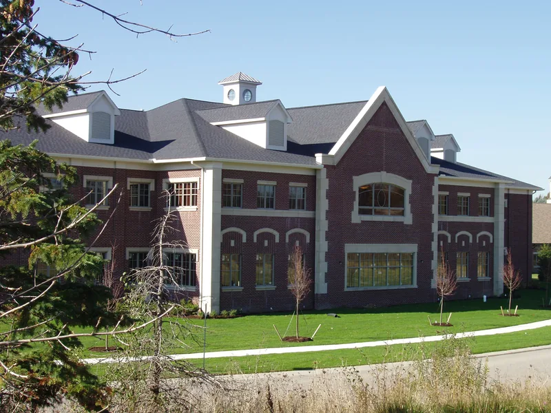 Brick office building with white trim and a lawn