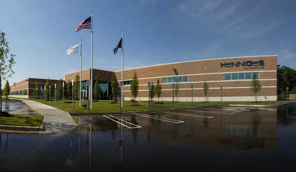 Henniges Automotive building with brick walls and flagpoles