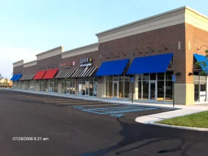 Bay River retail plaza with brick storefronts and blue awnings